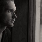Man looking through window