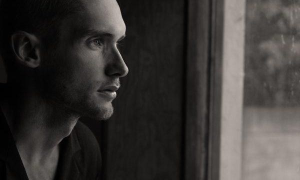 Man looking through window