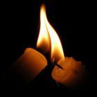 A candle being lit by another's flame