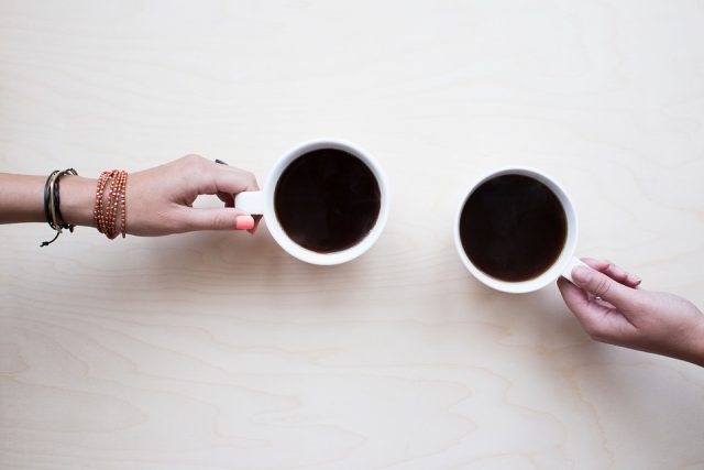hands holding coffee