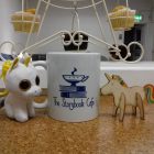 A coffee cup and some cupcakes