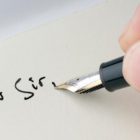 A pen writing on paper