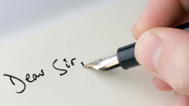 A pen writing on paper