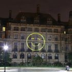 Happy face projected onto wall in peace gardens