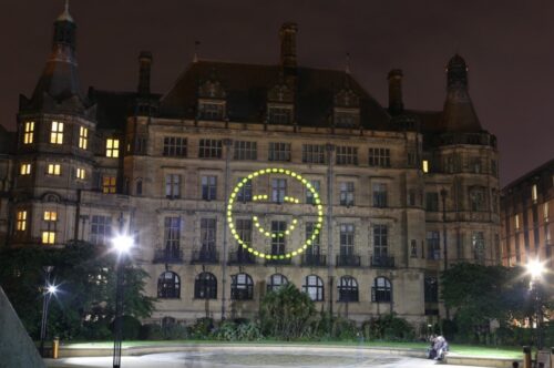 A happy face projected onto Sheffield Town Hall