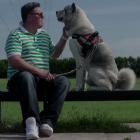 Bench with a man and dog sitting on it