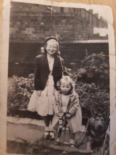 old black and white photo of a little girl and her Alsatian