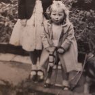 old black and white photo of a little girl and her Alsatian