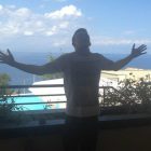 man standing on holiday balcony