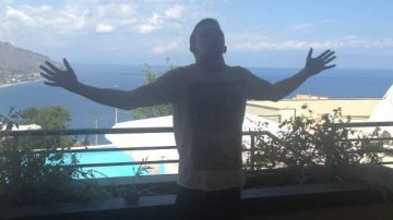 man standing on holiday balcony