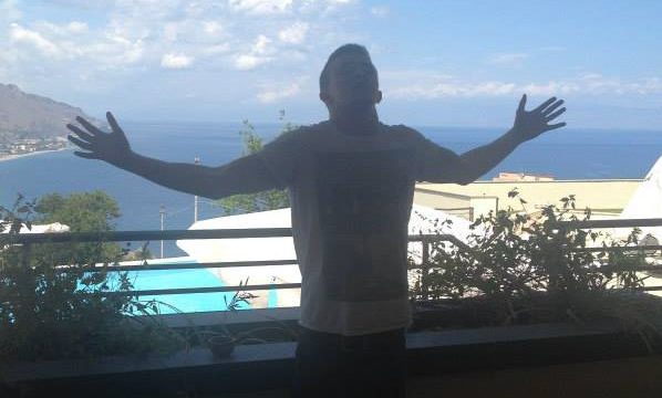man standing on holiday balcony