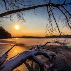 low sun shining over a frozen lake